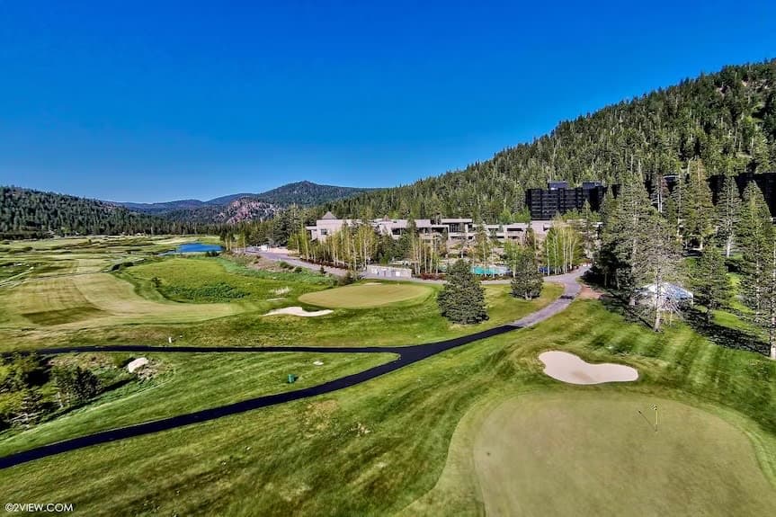 Everline Resort golf course, pool, and Lake Tahoe in summer